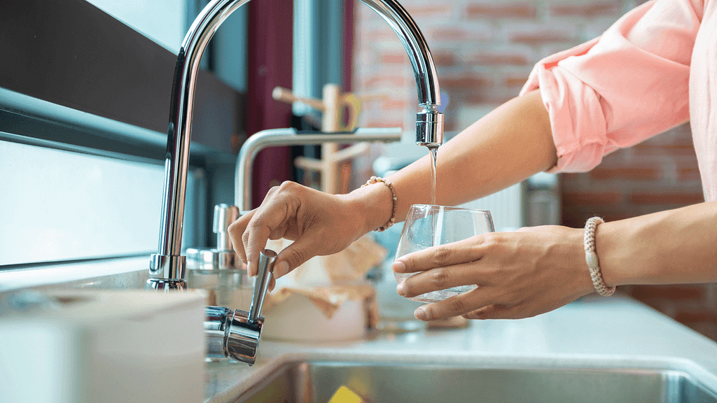 woman running faucet water